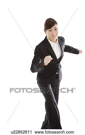 Stock Image - Businesswoman running. Fotosearch
