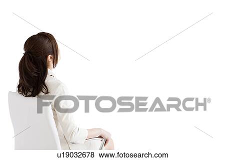 Stock Photo - Businesswoman sitting on chair. Fotosearch