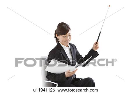 Businesswoman sitting on chair with binder and pointer View Large Photo Image Stock Photography - Businesswoman sitting on chair with binder and pointer. Fotosearch