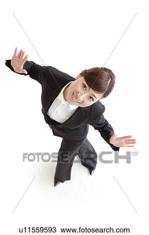 Businesswoman standing with arms raised View Large Photo Image Stock Image - Businesswoman standing with arms raised. Fotosearch