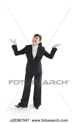 Businesswoman standing with arms raised View Large Photo Image Stock Photo - Businesswoman standing with arms raised. Fotosearch