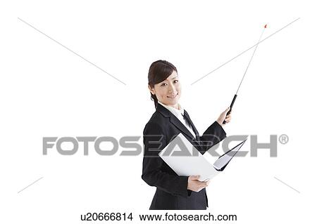 Picture - Businesswoman standing with binder and pointer. Fotosearch