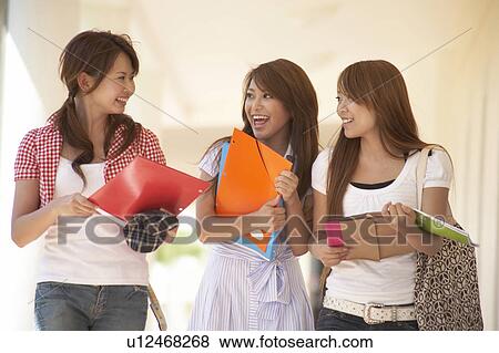 Stock Photo - College students walking in corridor, Guam, USA. Fotosearch