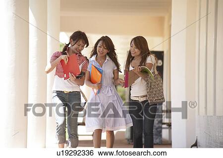 Stock Photograph - College students walking in corridor, Guam, USA. Fotosearch