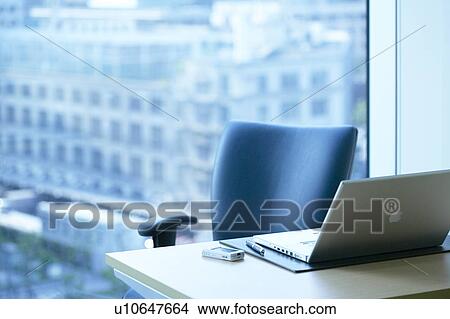 Picture - Desk in office with laptop, Tokyo Prefecture, Honshu, Japan. Fotosearch