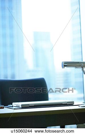 Desk in office with laptop, Tokyo Prefecture, Honshu, Japan View Large Photo Image Picture - Desk in office with laptop, Tokyo Prefecture, Honshu, Japan. Fotosearch