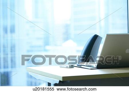 Stock Photography - Desk in office with laptop, Tokyo Prefecture, Honshu, Japan. Fotosearch
