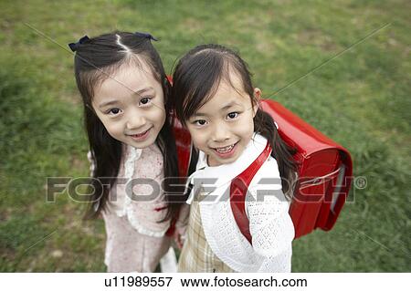 Stock Photo - Elementary schoolgirls looking at camera. Fotosearch