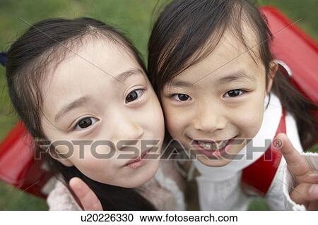 Elementary schoolgirls looking at camera making peace signs View Large Photo Image Stock Image - Elementary schoolgirls looking at camera making peace signs. Fotosearch