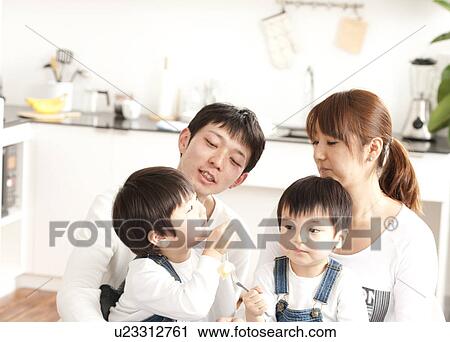 Stock Image - Family eating apple. Fotosearch