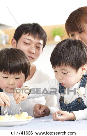 Stock Photograph - Family eating apple. Fotosearch