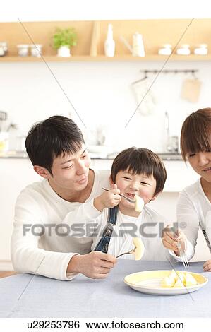 Stock Photograph - Family eating apple. Fotosearch