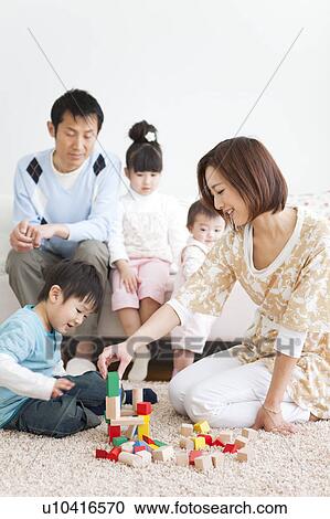 Family playing in living room View Large Photo Image Stock Image - Family playing in living room. Fotosearch