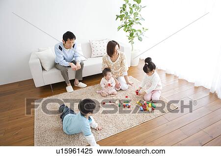 Family playing in living room View Large Photo Image Stock Photography - Family playing in living room. Fotosearch