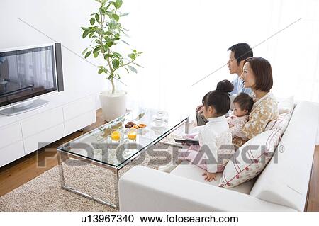 Family watching television View Large Photo Image Stock Image - Family watching television. Fotosearch