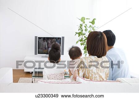 Stock Photo - Family watching television. Fotosearch