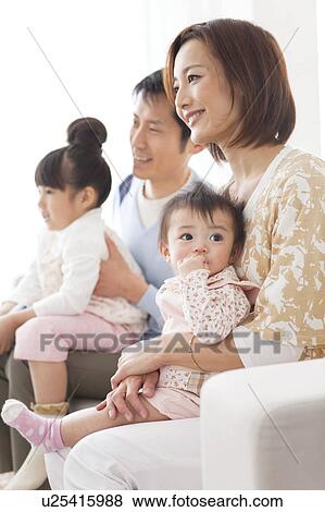 Family watching television View Large Photo Image Stock Photo - Family watching television. Fotosearch