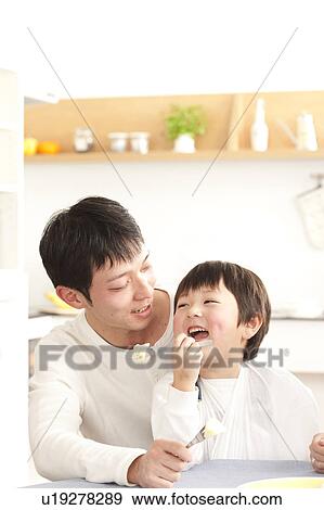 Stock Photo - Father and son eating apple. Fotosearch