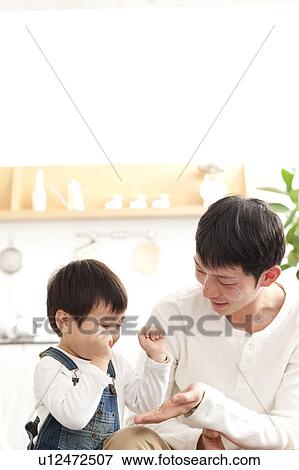 Father and son giving high five View Large Photo Image Stock Photo - Father and son giving high five. Fotosearch