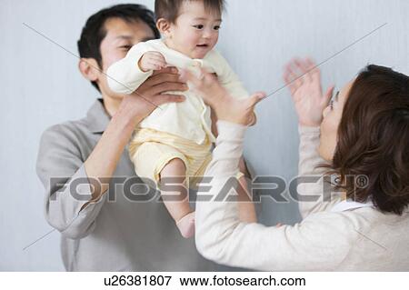 Stock Photo - Father lifting up baby. Fotosearch