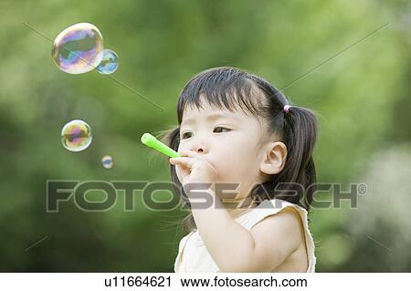 Girl blowing bubbles View Large Photo Image Stock Image - Girl blowing bubbles. Fotosearch