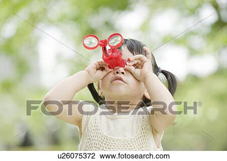 Girl looking through binoculars View Large Photo Image Stock Image - Girl looking through binoculars. Fotosearch