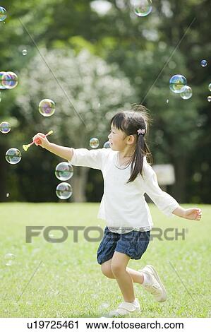 Girl playing with bubbles View Large Photo Image Stock Image - Girl playing with bubbles. Fotosearch