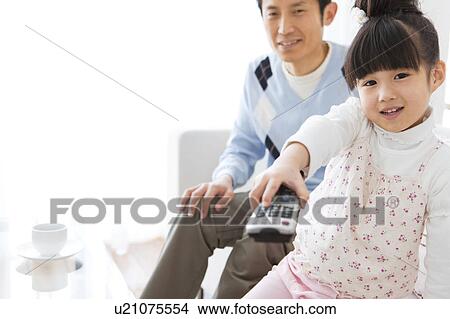 Picture - Girl with a remote control. Fotosearch