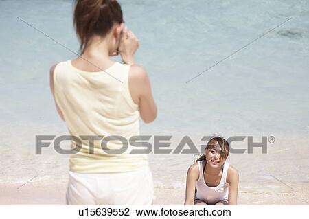 Japanese women taking pictures on beach, Guam, USA View Large Photo Image Stock Image - Japanese women taking pictures on beach, Guam, USA. Fotosearch