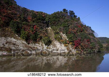 Stock Image - Kameyama Lake and Autumnal Trees. Fotosearch