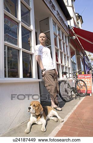 Stock Photo - Man and Dog Outside Shop. Fotosearch