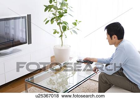 Man watching television View Large Photo Image Stock Photo - Man watching television. Fotosearch