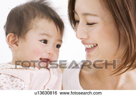 Mother carrying baby View Large Photo Image Stock Photograph - Mother carrying baby . Fotosearch