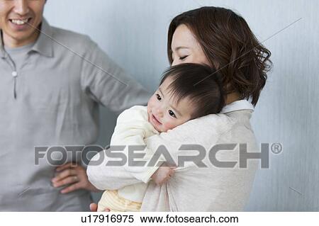 Mother carrying baby View Large Photo Image Stock Photography - Mother carrying baby . Fotosearch