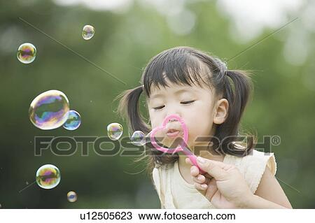 Mother helping daughter blowing bubbles View Large Photo Image Stock Image - Mother helping daughter blowing bubbles. Fotosearch