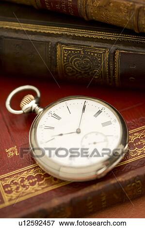 Old-fashioned pocket watch and books View Large Photo Image Stock Photo - Old-fashioned pocket watch and books. Fotosearch