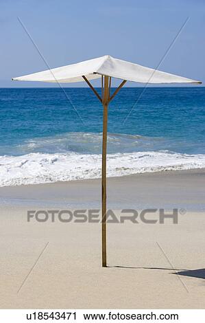 Stock Image - Parasol on Sandy Beach. Fotosearch