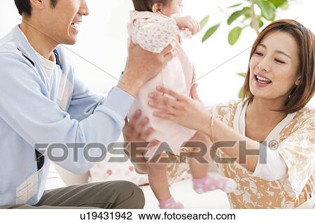 Parents carrying a baby View Large Photo Image Stock Image - Parents carrying a baby. Fotosearch