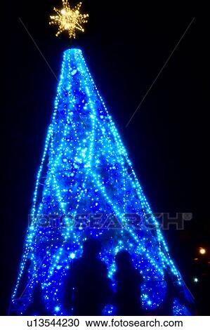 Stock Image - People Near Blue Christmas Tree. Fotosearch