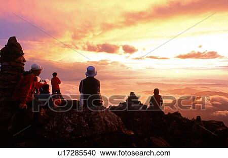 Stock Image - People watching Sea of Japan from Kasagadake Mountain at Dusk. Fotosearch