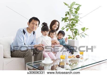 Portrait of family sitting on sofa View Large Photo Image Stock Image - Portrait of family sitting on sofa. Fotosearch