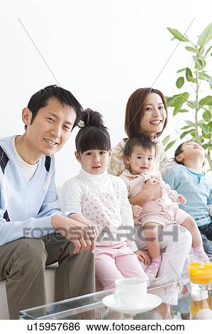 Portrait of family sitting on sofa View Large Photo Image Stock Photograph - Portrait of family sitting on sofa. Fotosearch