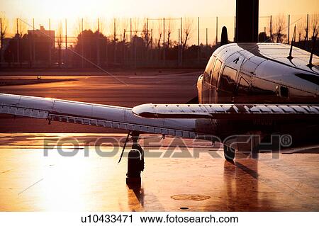 Stock Image - Propeller Airplane at Sunset. Fotosearch
