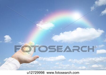 Stock Photo - Rainbow coming out of girl's hand, digital composite. Fotosearch