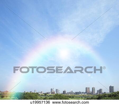 Stock Photograph - Rainbow over cityscape. Fotosearch