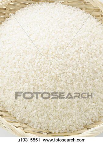 Stock Image - Rice in basket, close-up. Fotosearch