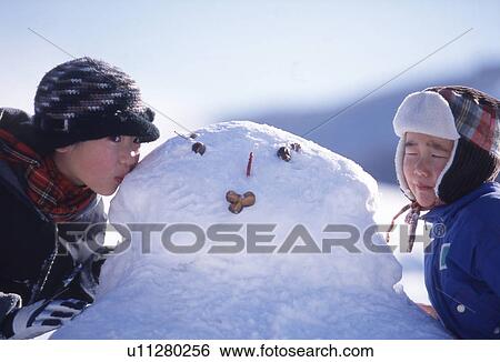 Sister and Brother Kissing Snowman View Large Photo Image Stock Photograph - Sister and Brother Kissing Snowman. Fotosearch