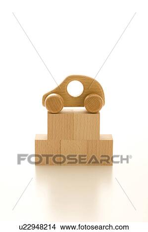 Stacked wooden blocks and toy car on top View Large Photo Image Picture - Stacked wooden blocks and toy car on top. Fotosearch