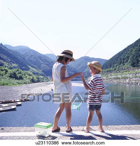 Stock Photograph - The Japanese child who plays with an insect collecting network in Kawabe. Fotosearch
