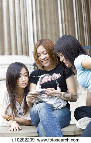 Three Women Looking at Digital Camera View Large Photo Image Stock Photo - Three Women Looking at Digital Camera. Fotosearch